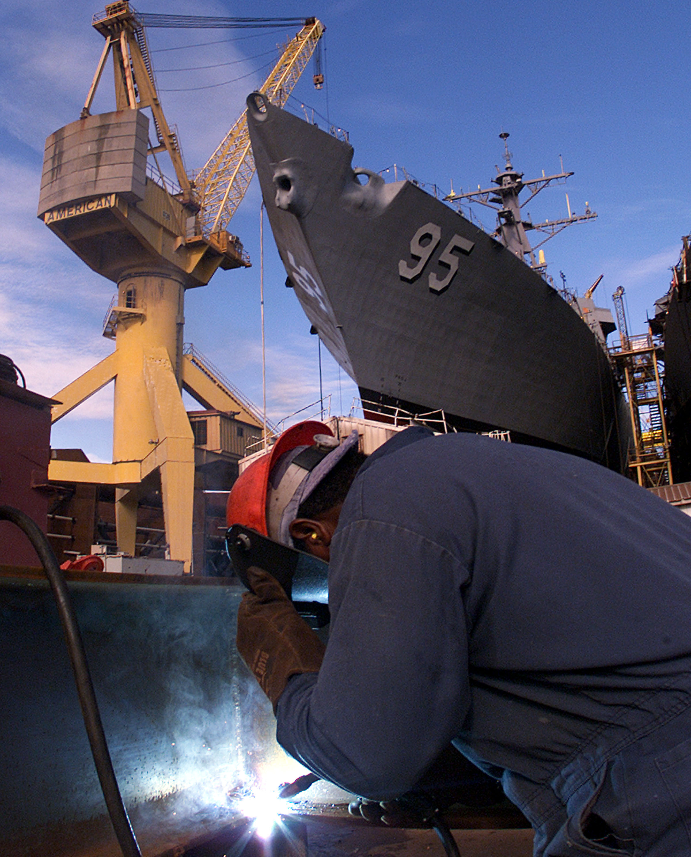Welder Eddie Lee Ervin welds on a fixture