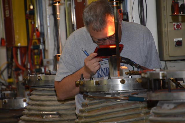 SYNOPTICS Employee Checks on Growing Crystal