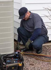 Contractor checking refrigerant on air conditioner