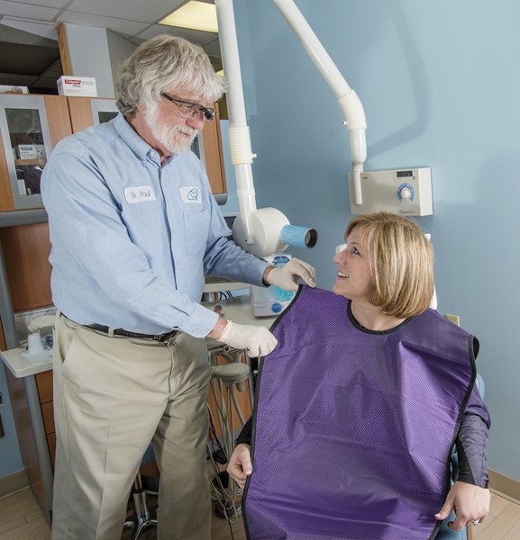 Patient wearing a DUX Dental violet lead-free x-ray apron