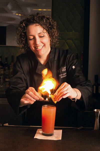 Libationist Joyce Garrison "lights" a COTA Flame